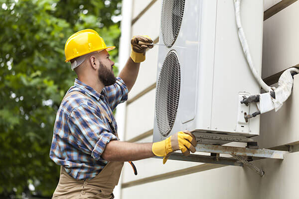 Long Island emergency mini split repair technician working on ductless head